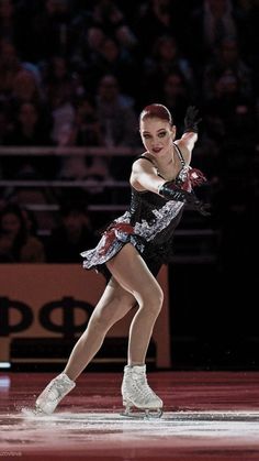 a female figure skating on an ice rink