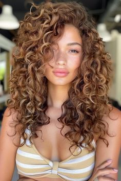 A person with curly hair wearing a striped bikini top. Autumn Lowlights For Brunettes, Honey Brown Hair Curly Highlights, Brown Hair With Warm Blonde Highlights, Best Hair Color For Soft Autumn, Honey Highlights Curly Hair, Short Honey Brown Hair, Curly Balayage Hair Brunettes