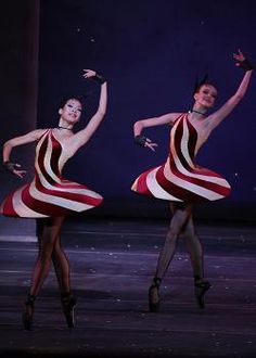 two dancers in red, white and black striped dresses