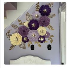 purple and yellow paper flowers are on the wall