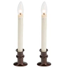 two white candles sitting on top of each other