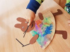 a child is making a paper plate reindeer craft