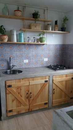 a kitchen with wooden cabinets and tile backsplashing on the wall above the sink