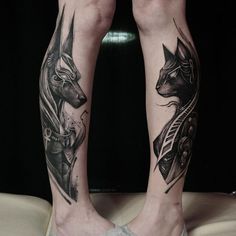 two people with tattoos on their legs and one has an animal head in the middle