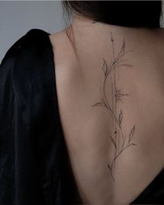 the back of a woman's neck with flowers on it