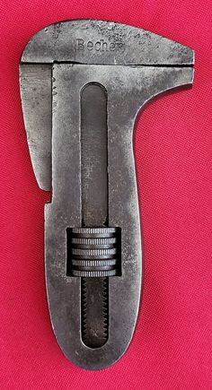 an old wrench is on a pink background with the word bedbat written below it