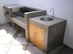 a sink and counter in a room with tile flooring on the ground, next to a window