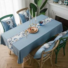 a dining room table with blue and white linens