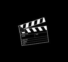 a black and white photo of a movie clapper on a dark background with the words production time written below it