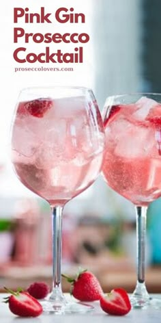 two pink gin cocktails with strawberries on the side