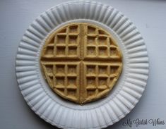 a waffle on a paper plate with the shape of a cross cut into it