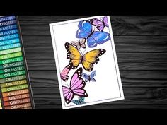 the coloring book is next to some colored crayons on a wooden table with an image of butterflies