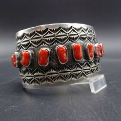 "HERBERT RATION (NAVAJO) BRACELET DESCRIPTION: An abundance of hand applied stamp work along with gorgeous specimens of old red Mediterranean coral, this bracelet will be a cherished addition to your collection of fine vintage Native American jewelry. MEASUREMENTS: Interior of the cuff measures 4 7/8\" with an additional 1 1/2\" non-adjustable gap. Total circumference: 6 3/8\" Measures 2 1/4\" straight across the widest part (from wrist bone to wrist bone) Bracelet face measures 1 1/4\" wide (th Red Southwestern Style Collectible Jewelry, Handmade Southwestern Red Cuff Bracelet, Red Southwestern Cuff Bracelet As Gift, Red Southwestern Cuff Bracelet Gift, Handmade Red Southwestern Cuff Bracelet, Bone Bracelet, Jewelry Measurements, Bones Bracelet, Vintage Native American Jewelry