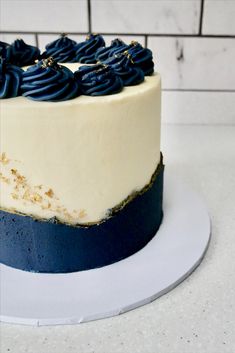 a blue and white frosted cake on a plate