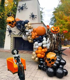 halloween decorations and balloons in front of a fireplace