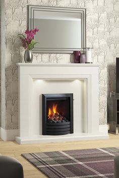 a white fireplace with a mirror above it and a fire place in front of it