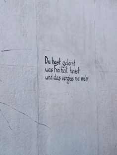 graffiti written on the side of a white building