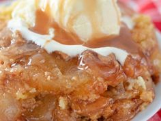 a piece of apple cobbler with ice cream and caramel sauce on the top