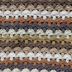 a crocheted blanket is shown with different colors