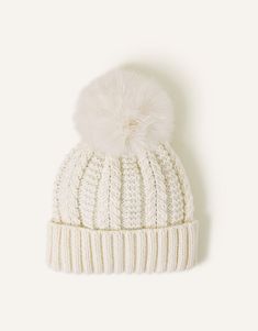 a white hat with a pom - pom on top