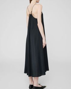 Indulge in luxury with the Anine Bing Aida Dress in Black. Made from a lightweight cotton-viscose blend, this midi-length dress boasts a soft-yet-crisp look and feel. Thin, adjustable spaghetti straps and a boxy, loose fit create a relaxed yet sophisticated silhouette. Elevate your style with this seasonal must-have. THIS ITEM IS FINAL SALE. AS WE PREPARE TO CLOSE OUR DOORS AT THE END OF THE YEAR, PLEASE NOTE THAT ALL SALES ARE FINAL AND NOT ELIGIBLE FOR PRICE ADJUSTMENTS AT A LATER DATE. Denim Sweater, Midi Length Skirts, Anine Bing, Cotton Viscose, Midi Length Dress, Seasonal Fashion, Sweater Blouse, Swimwear Accessories, Skirt Top