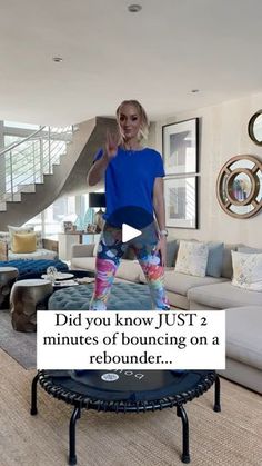 a woman standing on top of a trampoline in a living room