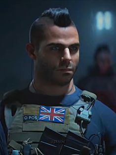 a man in a space suit with a british flag on his chest