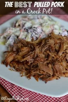 the best pulled pork in a crock pot is served on a plate with coleslaw