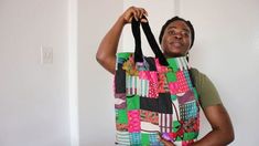 a woman holding a colorful bag in her hands