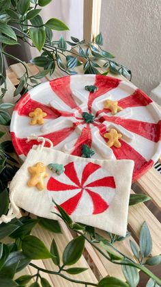 a plate with candy canes on it next to a potted plant