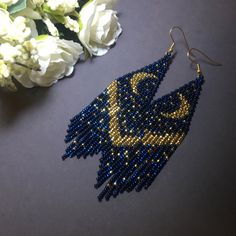 "These dark blue gold beaded earrings pair amazingly with any outfit, dressy or casual. They are made of high-quality Czech colored beads with steel . Colors: bdark blue, gold Length: 4.7 inches (12 cm) Width: 1.1 inches (3 cm) Materials: Czech \"Preciosa\" beads Durable synthetic thread medical steel" Blue Beaded Earrings With Gold Beads For Festivals, Bohemian Blue Earrings With Gold Beads, Handmade Blue Evening Earrings, Party Blue Beaded Earrings With Gold Beads, Blue Bohemian Chandelier Earrings For Party, Elegant Gold Beaded Earrings For Festival, Beaded Moon Earrings, Blue Gold Earrings, Gold Beaded Earrings