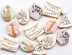 several decorated cookies with animals and giraffes on them