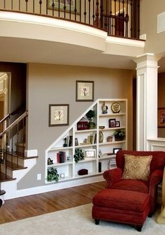 a living room filled with furniture and a stair case