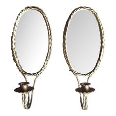 a pair of mirrors that are next to each other on a white surface with rope around them