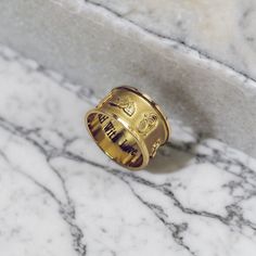 Introducing our exquisite 18k Gold Cartouche Ring, a stunning piece of jewelry that allows you to personalize and express your unique style. What sets this Cartouche Ring apart is its customization options. You can make it truly one-of-a-kind by having your name or the name of your loved one in Egyptian Hieroglyphics or English on the outer side of the ring. This unique feature adds a touch of mystique and fascination. In addition, you also have the option to personalize the inside of the ring. Symbolic Brass Engraved Ring For Wedding, Symbolic Brass Engraved Ring For Anniversary, Yellow Gold Brass Promise Ring, Symbolic Engraved Brass Ring For Anniversary, Symbolic Yellow Gold Engraved Brass Ring, Symbolic Engraved Wedding Ring, Symbolic Engraved Wedding Ring With Engraving Option, Symbolic Wedding Engraved Ring, Yellow Gold Engraved Ring In Brass