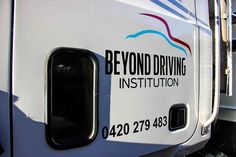 the side of a truck that says beyond driving institution