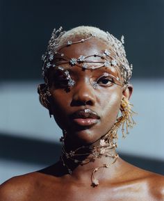 a woman with white hair and jewelry on her face