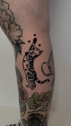 a person with a cat tattoo on their leg