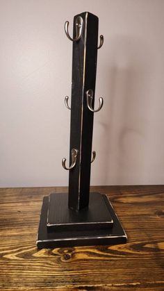 a pair of metal hooks on top of a wooden table