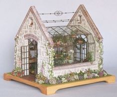 a miniature house made out of clay and flowers