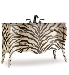 a zebra print dresser with a sink and faucet