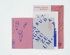 three notebooks with different designs and writing on the covers, including one for design museum budapest