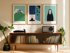 three framed pictures hang on the wall next to a record player