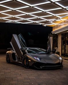 a silver sports car parked in front of a building