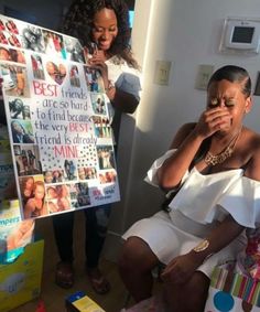 a woman sitting on a chair in front of a sign with pictures and people around her