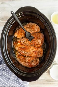 the chicken is being cooked in the slow cooker