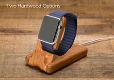 an apple watch on a wooden stand with the words two hardwood options written below it