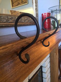 a fire place with a wooden mantle and metal brackets on the mantel above it