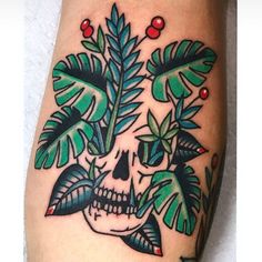 a skull with leaves and berries on it's head is shown in this tattoo design