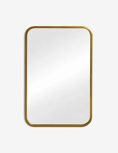 a square gold frame mirror on a white wall